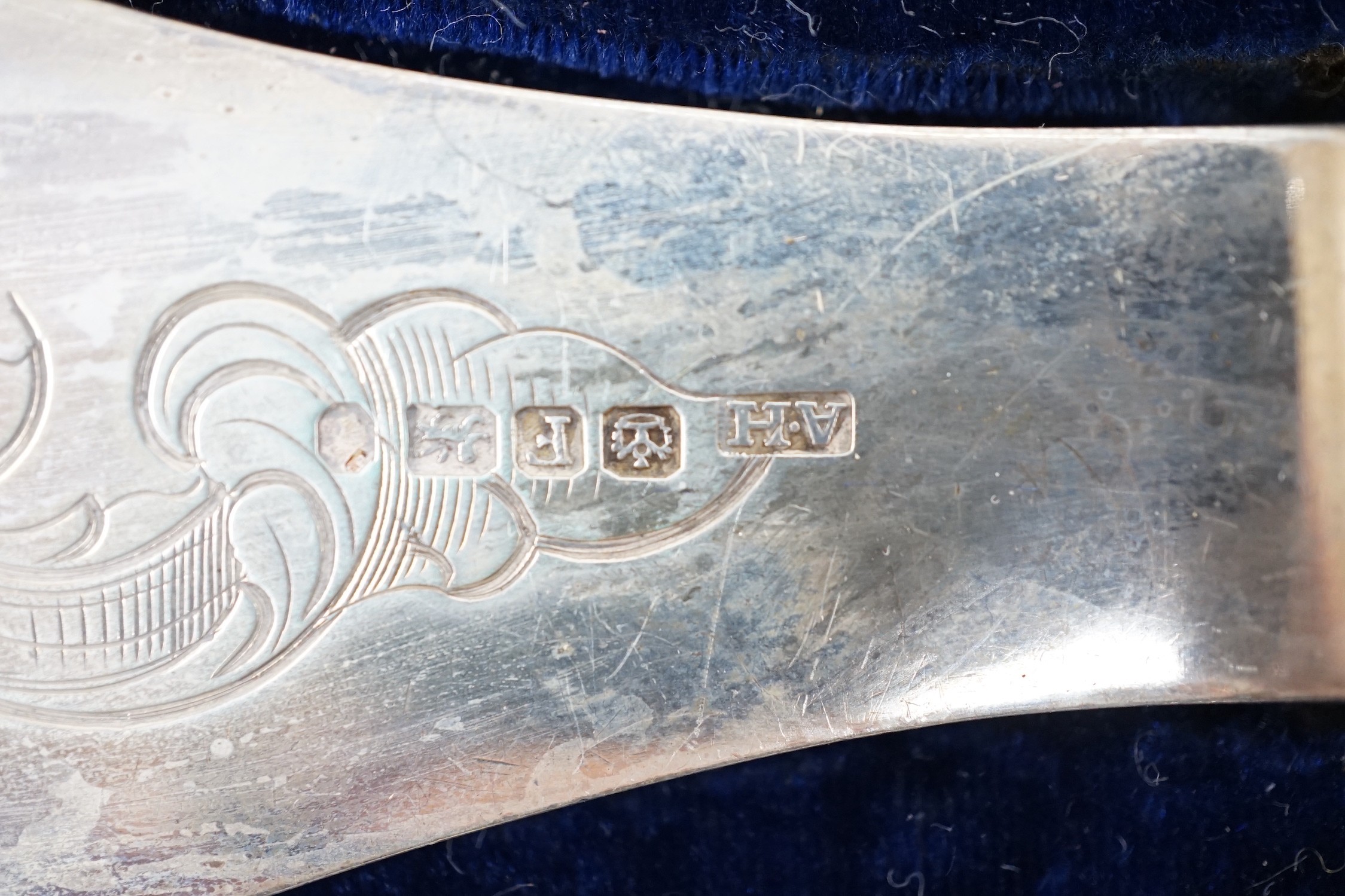 A cased pair of Victorian silver fish servers, by Aaron Hadfield, Sheffield, 1849, with engraved decoration, slice 30.8cm, (loaded handles).